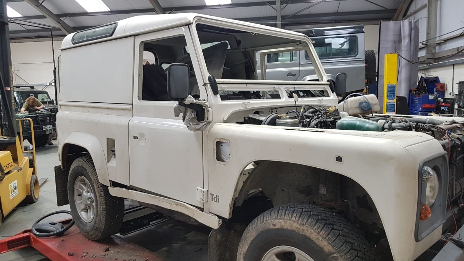 White Defender 90 back together in the workshop after its bulkhead replacement